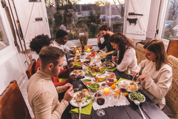 istock Friends enjoying a delicious Christmas dinner in a rustic cabin 1362894693