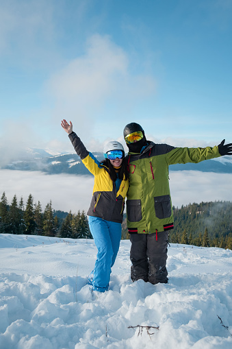 couple snowboarder ans skier portrait mountains on the background