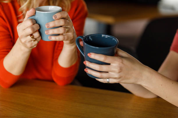 istock Two businesswomen holding coffee cups while casually chatting 1362896174