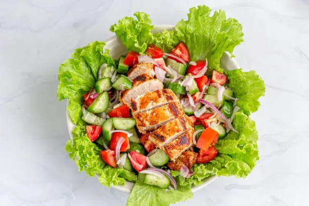 Chicken Salad of Lettuce, Cucumber, Onion and Tomato. Healthy Lunch Menu. Diet Food.