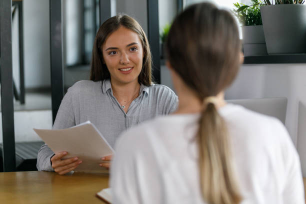 istock Two young businesswomen sitting opposite each other, co-working on a project 1362896678