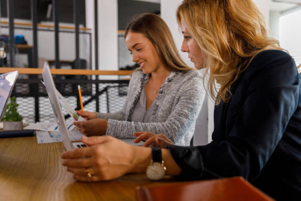 istock Two diligent businesswomen reviewing project repots during a meeting 1362896703