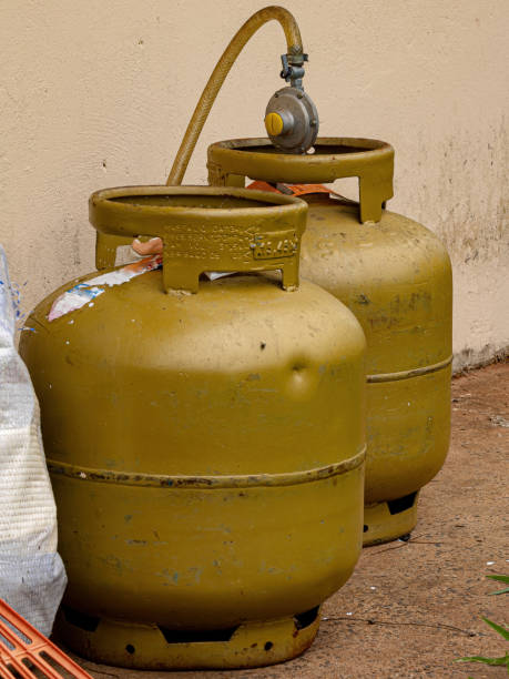golden cooking gas cylinders - botija de gas imagens e fotografias de stock