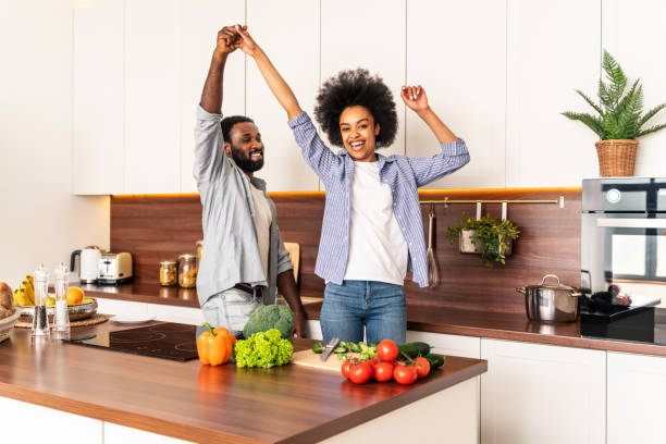 istock Afro american couple cooking at home 1362903079