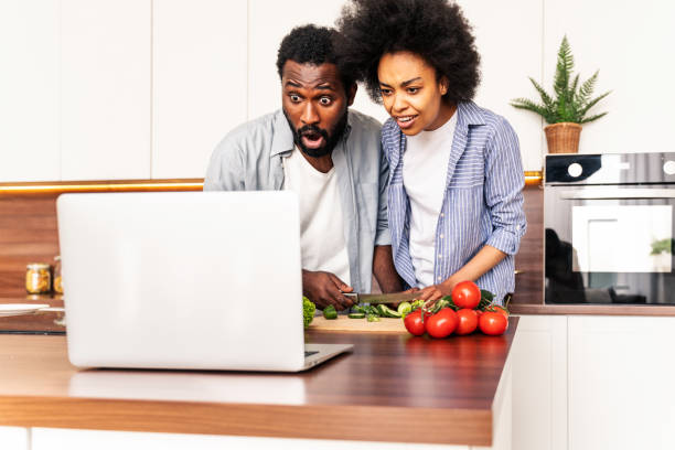 istock Afro american couple cooking at home 1362903130