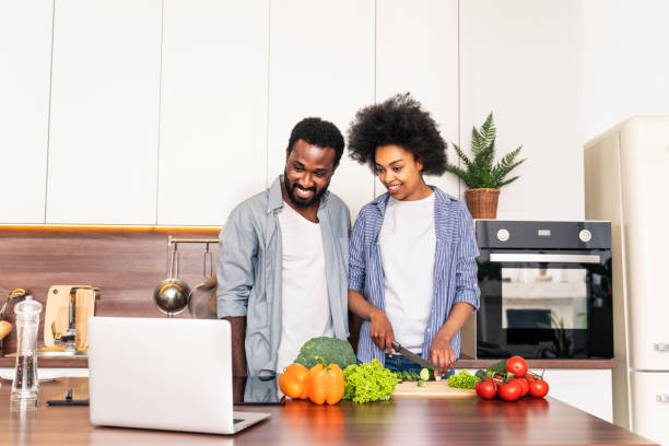 istock Afro american couple cooking at home 1362903335