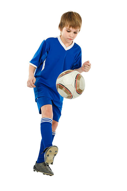istock boy - soccer player with ball 136290349