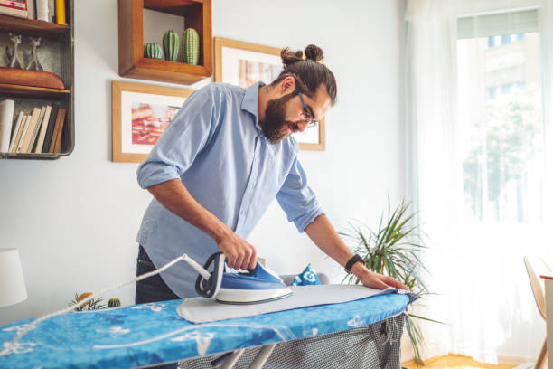 istock Young man ironing his shirt 1362904384
