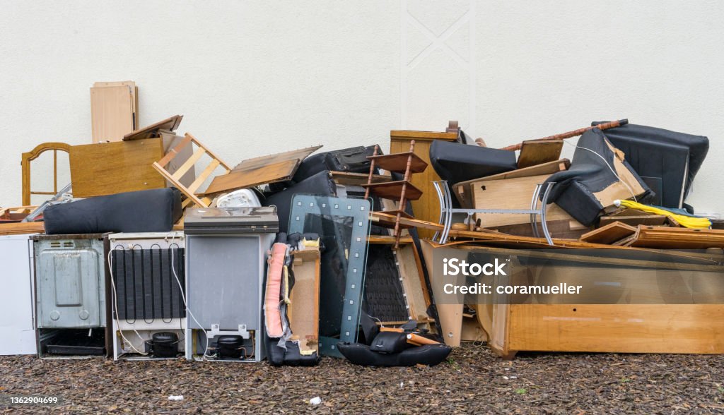 Bulky waste Bulky garbage heap in front of a house wall Garbage Stock Photo