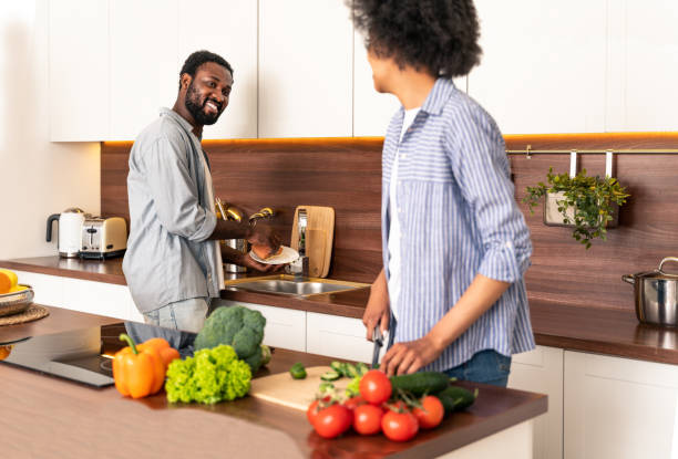 istock Afro american couple cooking at home 1362905570