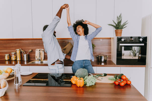 istock Afro american couple cooking at home 1362905743