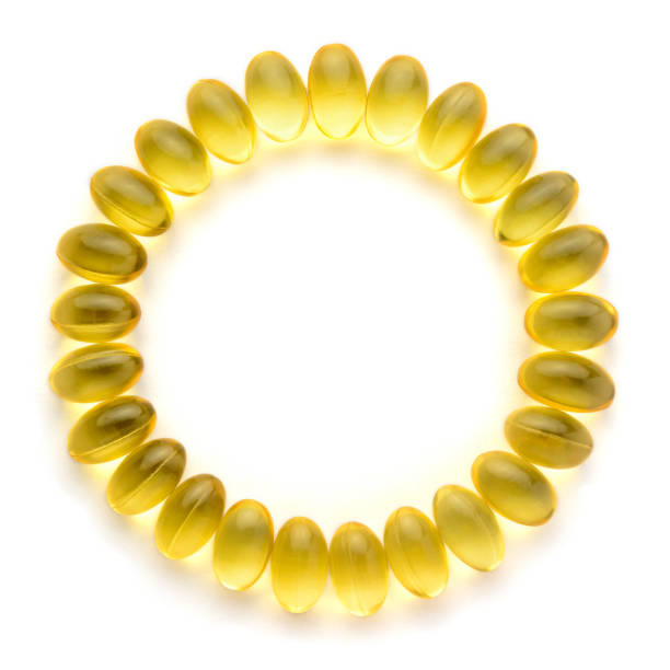 oil capsules, circle pattern of omega 3 and vitamin supplement oil capsules, circle pattern of omega 3 and vitamin supplement isolated on white background, healthy lifestyle concept, with copy space vitamin photos stock pictures, royalty-free photos & images