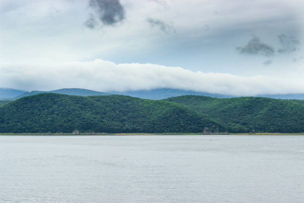 The mountains beyond Jingpo Lake are shrouded in fog