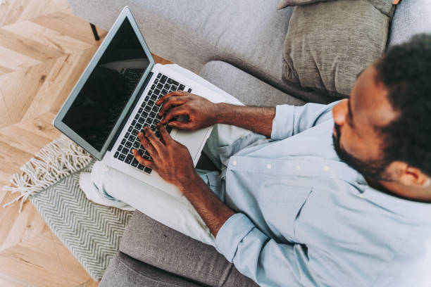 istock Afro american man working with computer laptop at home 1362908590