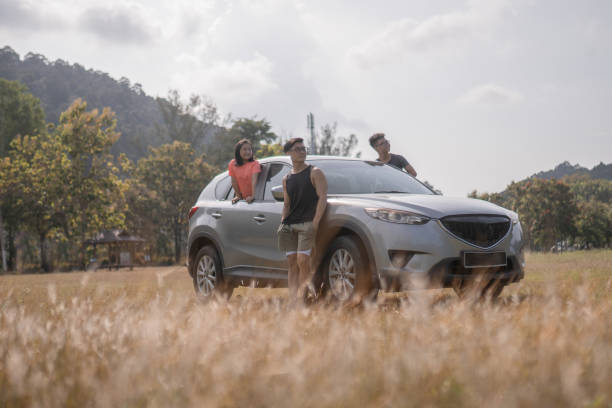 Asian Chinese family enjoying traveling in the off-road car stock photo