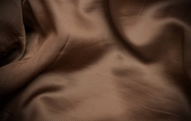 istock Golden taffeta silk fabric curve making a background 1362911505