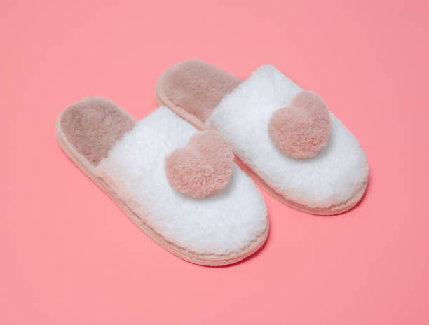 istock Indoor women's slippers pink with white on a pink background. 1362913019