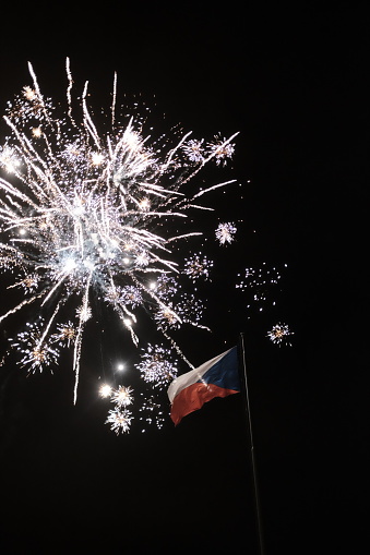 Czech flag waving with fireworks in the background celebrating new years eve in Prague
