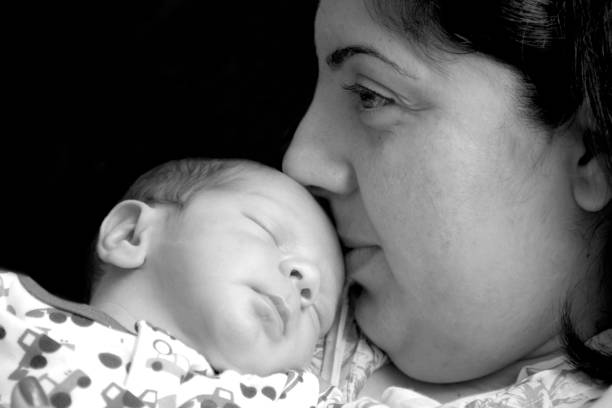 istock Maternal affection, Peaceful baby boy sleeping on mother's chest. 1362914303