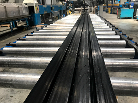 Large-size profile being extruded in rubber factory