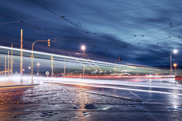 Photo of a tram in a city street during night time