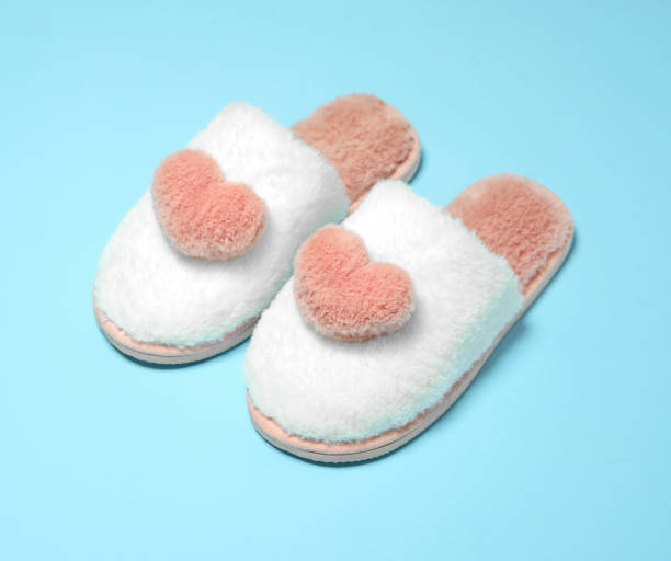 istock Home soft female slippers pink with white on a blue background. 1362917188