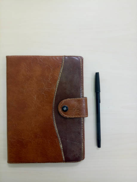 istock a old notebook with pen. notebook on white wooden background with copy space area 1362918822