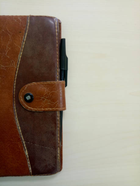 istock a old notebook with pen. notebook on white wooden background with copy space area 1362918989