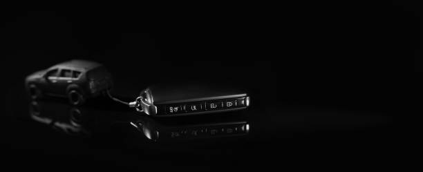 istock car model pulls remote key on black background. buy new car concept. banner copy space 1362919971