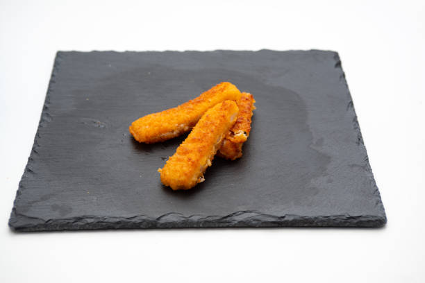 istock fish sticks, on cast iron plate isolated on white background 1362921040