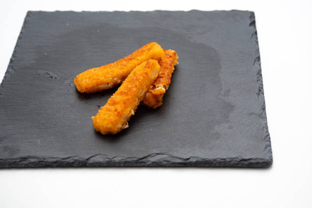 istock fish sticks, on cast iron plate isolated on white background 1362921044