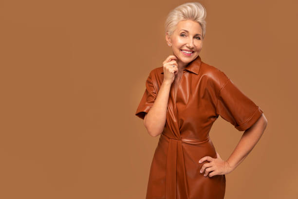 Beautiful blonde caucasian middle aged woman with short hairstyle smiling to the camera. Fashion photo. Elegant businesswoman. Beautiful blonde caucasian middle aged woman with short hairstyle smiling to the camera. Fashion photo. Elegant businesswoman. A lot of copy space. middle aged woman fashion stock pictures, royalty-free photos & images