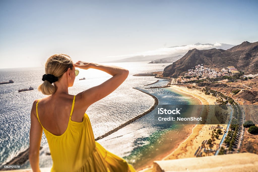 Amazing place to visit. Woman looking at the landscape of Las Teresitas beach and San Andres village, Tenerife, Canary Islands, Spain. Amazing place to visit. Woman looking at the landscape of Las Teresitas beach and San Andres village, Tenerife, Canary Islands, Spain. Tourism. Vacation. Travel. Tenerife Stock Photo
