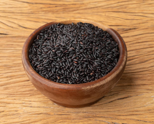 istock Raw black rice in a bowl over wooden table 1362921388