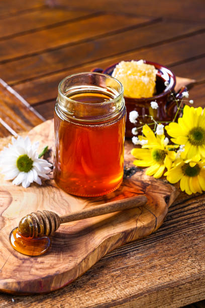 istock Honey jar with on rustic wooden table 1362924521
