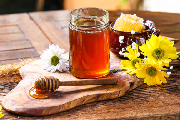 istock Honey jar with on rustic wooden table 1362924523