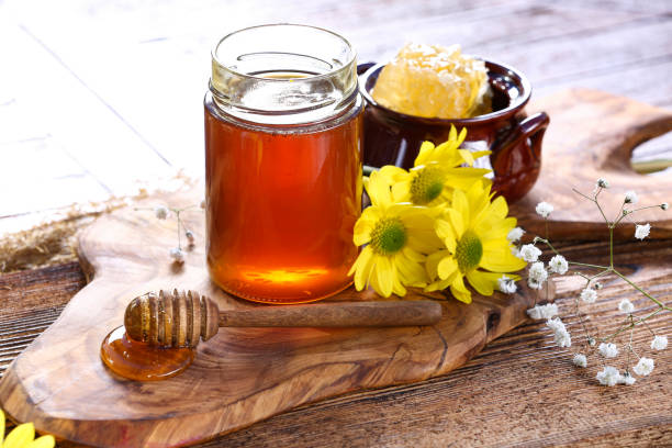 istock Honey jar with on rustic wooden table 1362924634