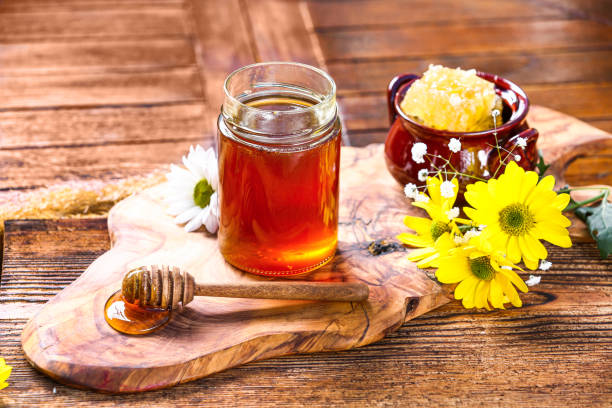 istock Honey jar with on rustic wooden table 1362924637