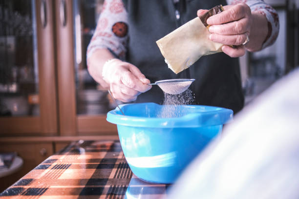istock Grandmother using powdered cocoa in her recipe 1362925261