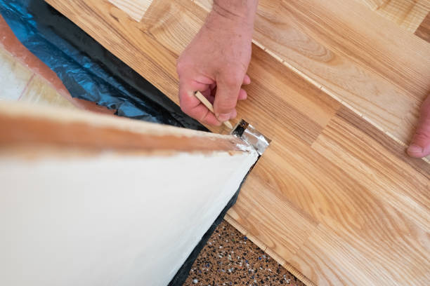 istock Caucasian man installing wood parquet board during flooring work 1362926377