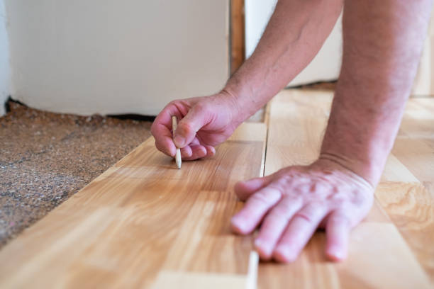 istock Caucasian man installing wood parquet board during flooring work 1362926413