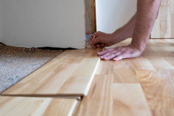 istock Caucasian man installing wood parquet board during flooring work 1362926445