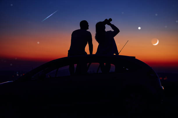 istock Couple stargazing together with a astronomical telescope. 1362927826