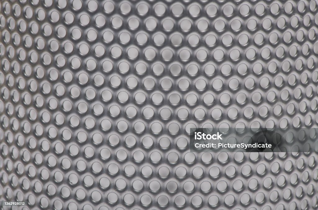 macro round curved metal perforated sheet background Close up of round curved silver gray metal perforated sheet to use as background Perforated Stock Photo