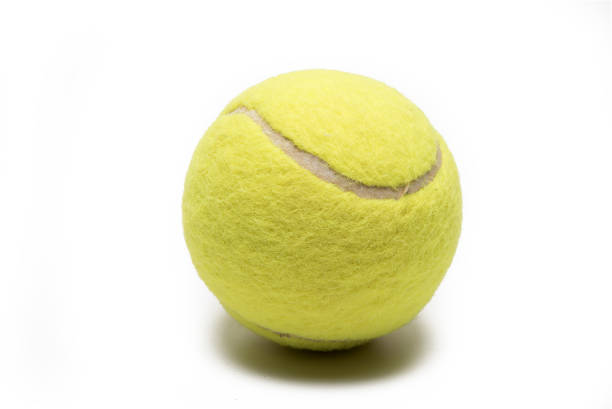 istock Close up yellow tennis ball white background 1362928056