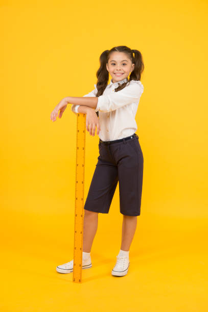 istock Exploring stem. Geometry school subject. School adorable student study geometry. Kid school uniform hold ruler. Education and school concept. Sizing and measuring. Pupil cute girl with big ruler 1362930483