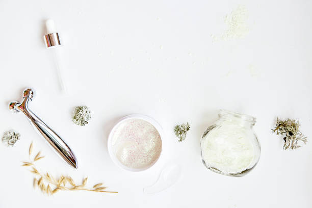 istock Face care cosmetics set. Massager, alginate mask and patches. Dermatology multiuse cosmetics, multitasking beauty. Scinimalism concept, polytasking functions. Natural eco forest moss and oat 1362931339