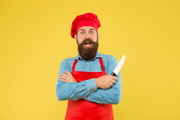 istock Restaurant food. Hipster handsome cook hold sharp professional knife 1362931527