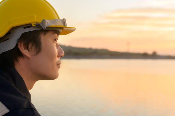 istock A male engineer wearing a protective helmet at sunset. 1362931756
