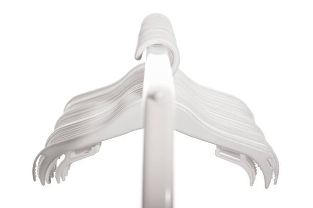 White plastic hangers for clothes hanging on rod from clothing rack. Isolated on white background.. White plastic hangers for clothes hanging on rod from clothing rack. Isolated on white background. clothes hanger rod stock pictures, royalty-free photos & images
